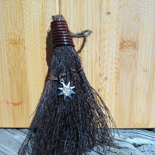 Witchy broom with silver sun charm